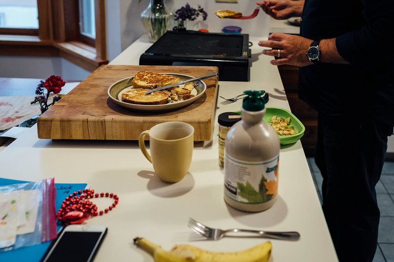 Father makes french toast for breakfast in the kitchen.