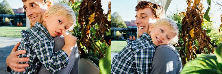 Father holds little boy walking down the path.