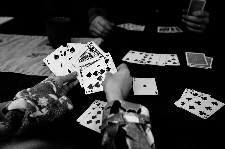 Black and white. Father and son playing game of cards.