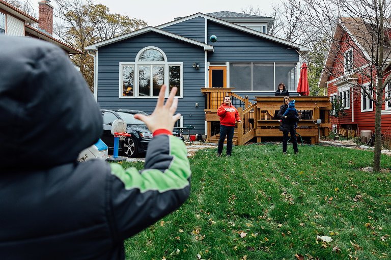 Family playing football in backyard.