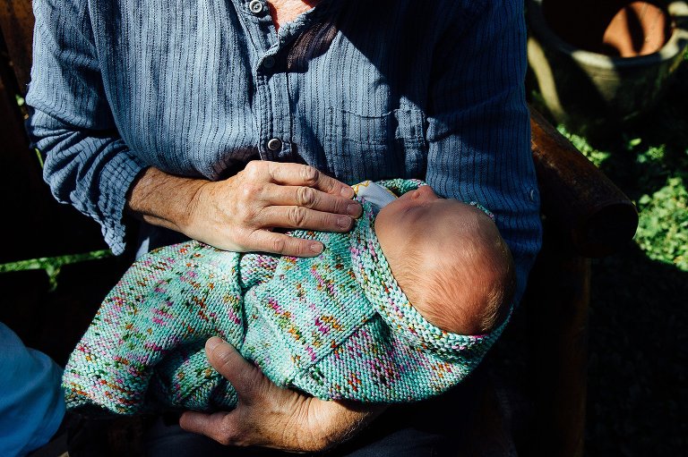 Woman holds sleeping newborn baby.