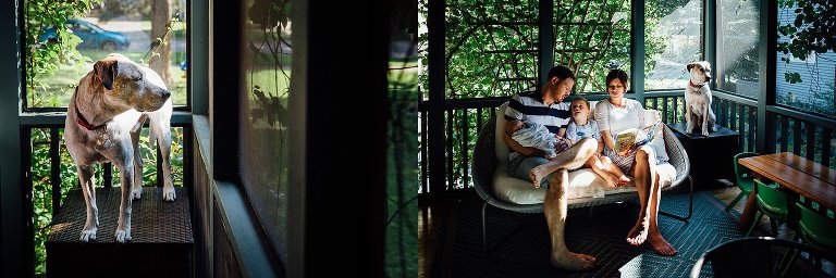 Family sits together on the back porch reading a book. dog sitting on the table next to the.