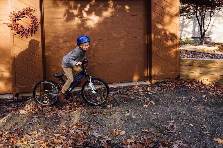 boy rides back with dad's shadow on wall during autumn session at home 