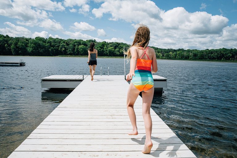 Mom races toward the end of the dock and 9yo starts after her. 
