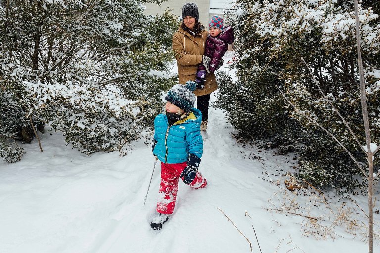 Girls and mom enter backyard. 