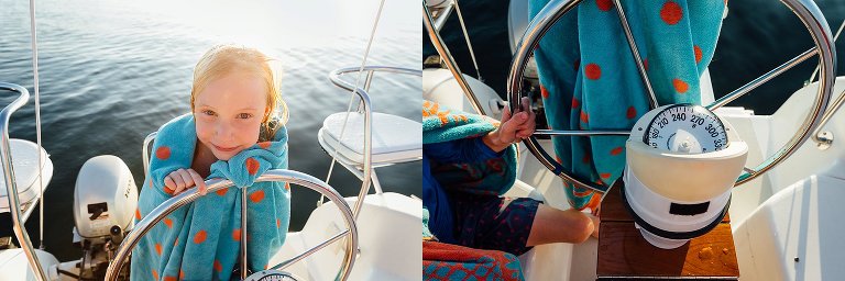 Girl stands behind sailboat wheel; boat instruments.  Madison family photographer sailing on lake mendota
