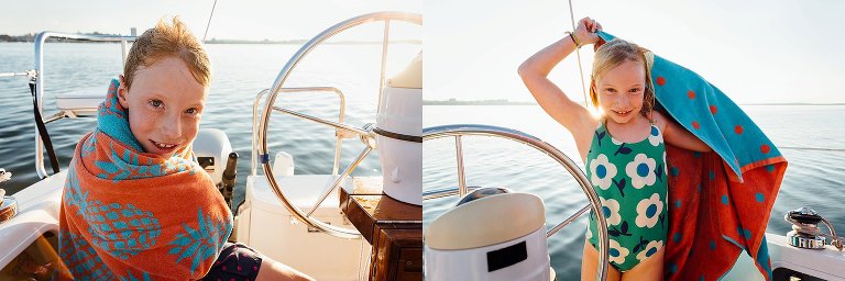 Boy in towel is camera aware. Girl in towel is camera aware. Sunset in background.