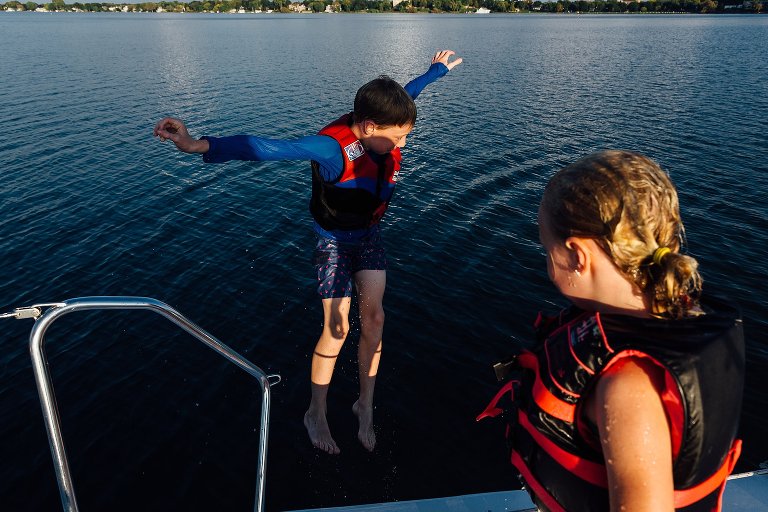 Boy jumps into lake. His sister's shadow lands on him.