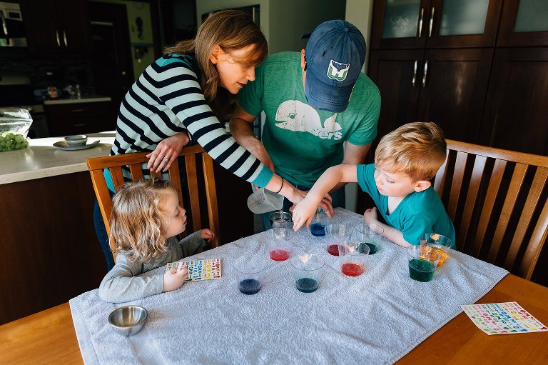 Family dyes Easter eggs together. 