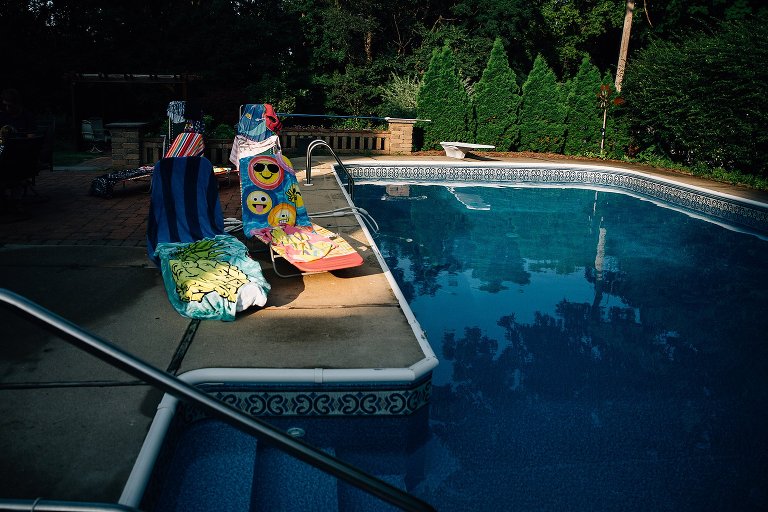 Still scene. Colorful beach towels draped over chairs to dry in the late afternoon light. 