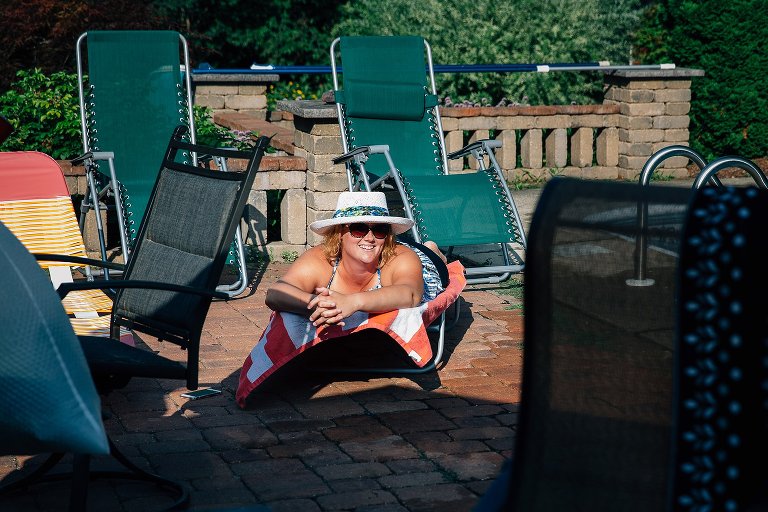 woman smiles while lying in the sun. 