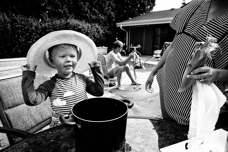 black and white. Boy wears hat and smiles. 