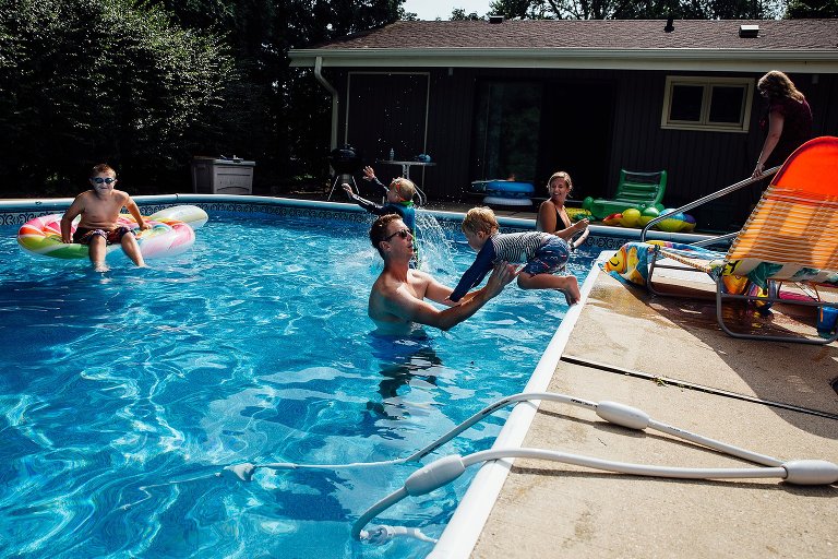 Boy in mid-jump into the pool. 