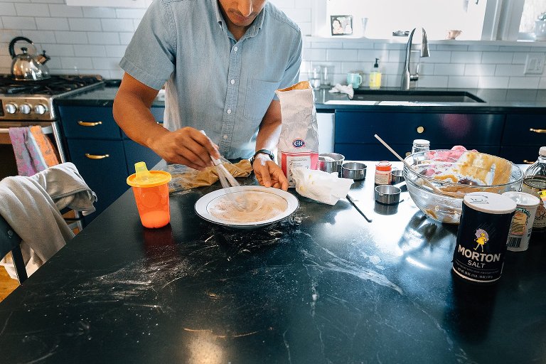 Dad whisks a cinnamon sugar mixture for the donuts 