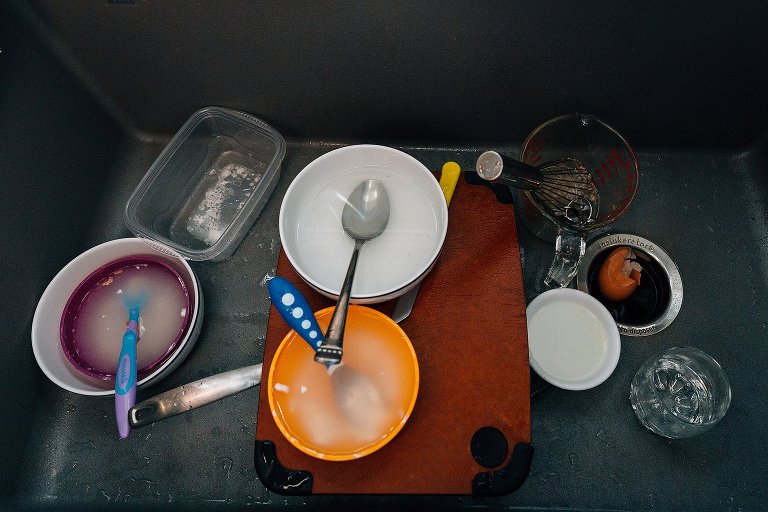 Many colorful circle dishes in the sink during a Madison family photographer session