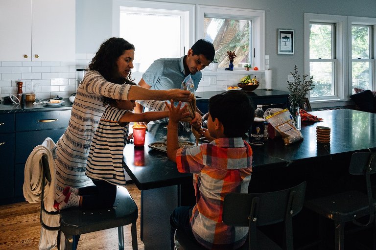Family of 4 make donuts in their kitchen during a Madison family photographer session