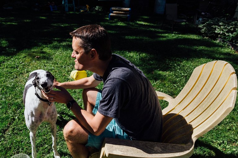 Man and Greyhound smile in the sun