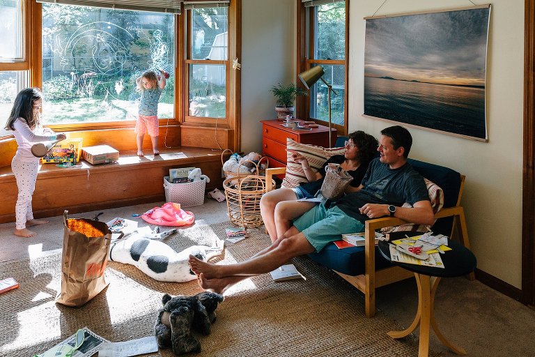 family of four sits in the living room on a sunny spring Saturday morning