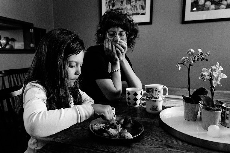 mom watches daughter eat pancakes 