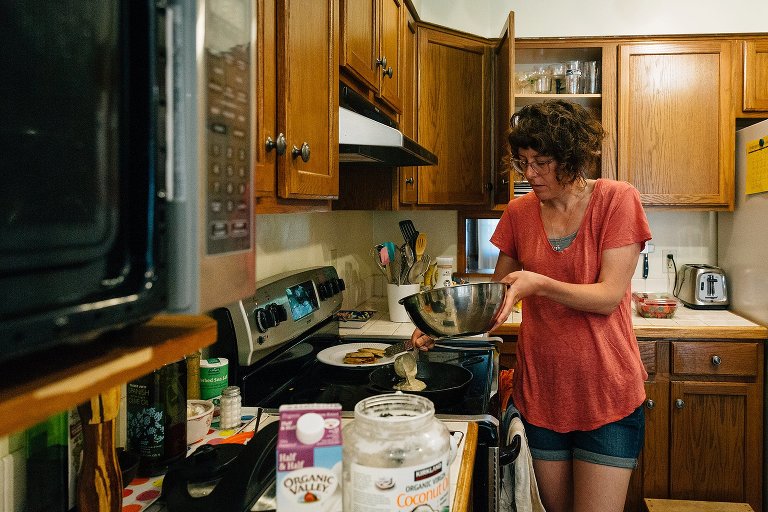 mom pours pancake batter into pan