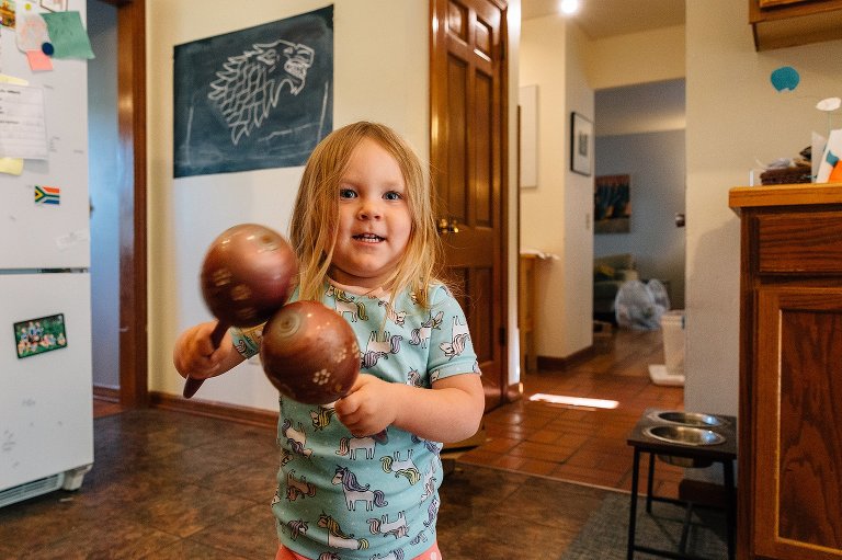 Girl uses maracas in the kitchen