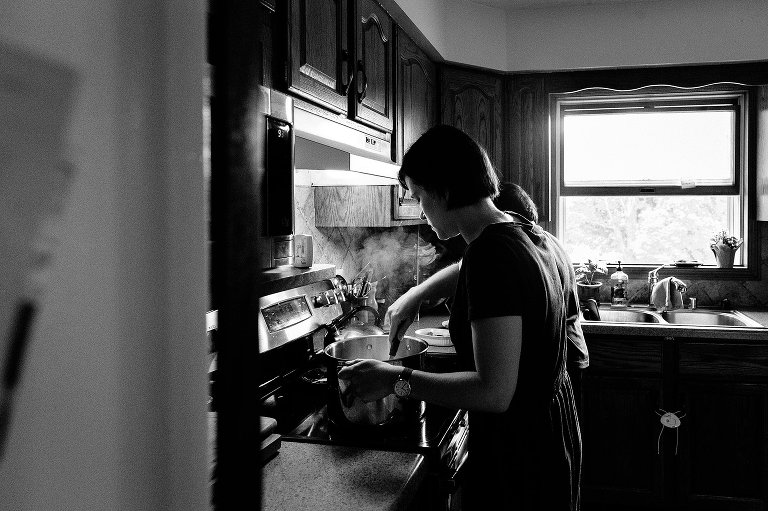 Woman stirs pot of oatmeal, steam rises