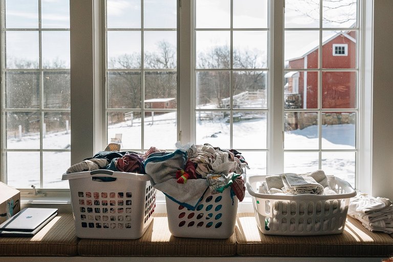 Folded laundry baskets in the window. 