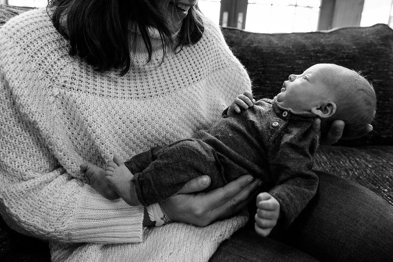 Black and white. Mom holds alert baby. 