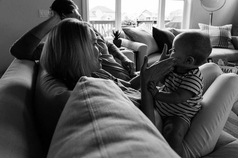 Mom gently touches baby cheeks during a Family Photography session in MIddleton. Black and white.