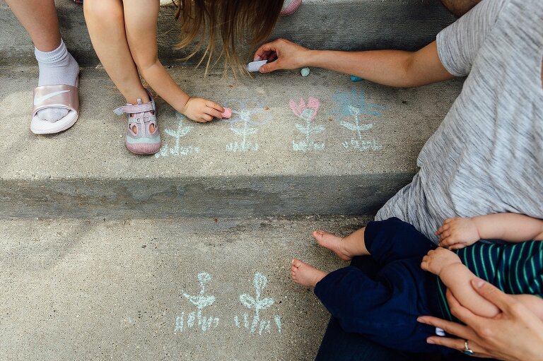 Family colors chalk flowers on the front steps 