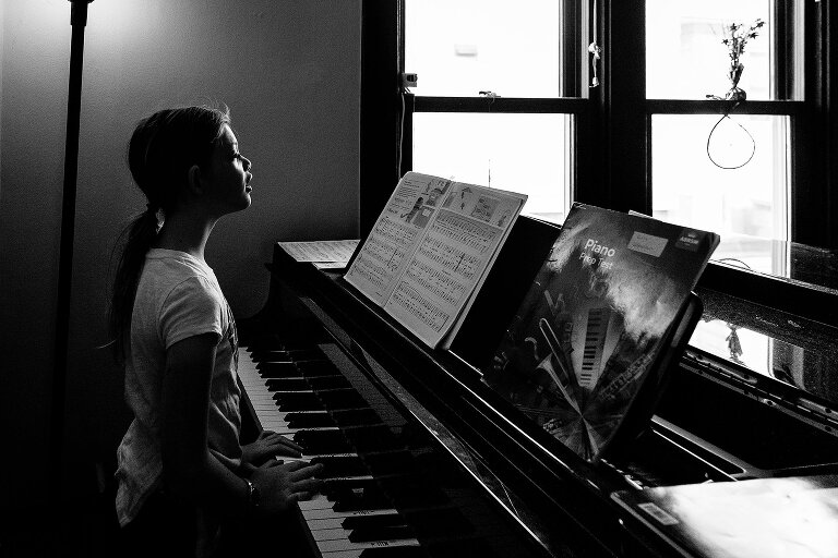 Pre-teen girl plays the piano.