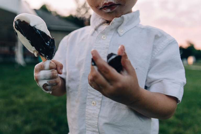 Boy eats a melting Dilly Bar. 