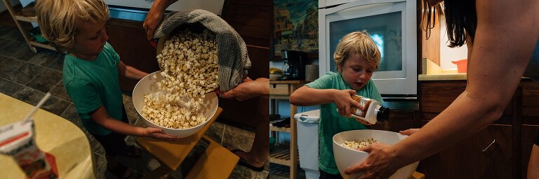 Boy holds bowl as mom dumps popcorn in. Boy shakes salt into bowl. 