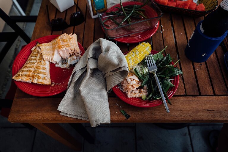 Summer dinner left mostly uneaten. Salmon, corn on the cob, salad. 