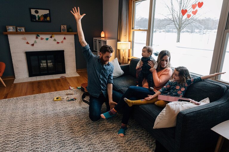 Father is teaching girl to dance. 