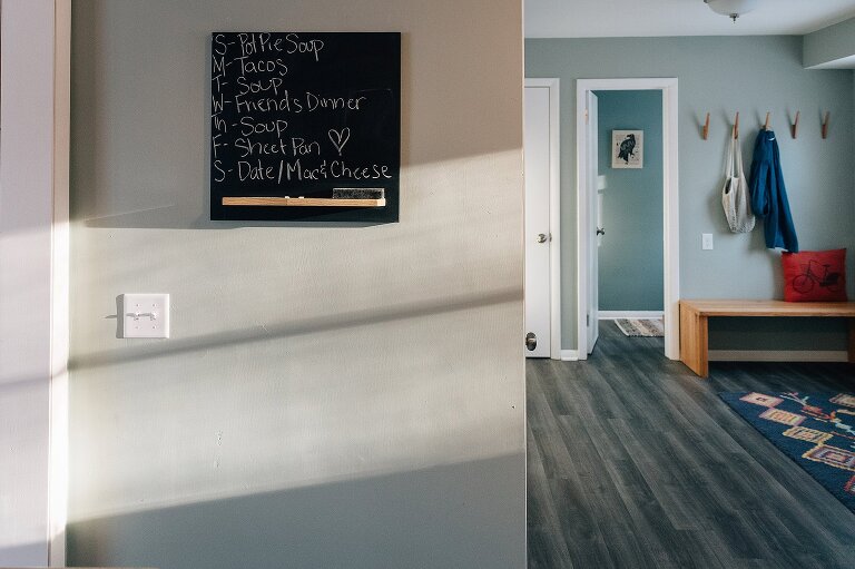 Window light in the kitchen illuminating chalk board menu for the week. 