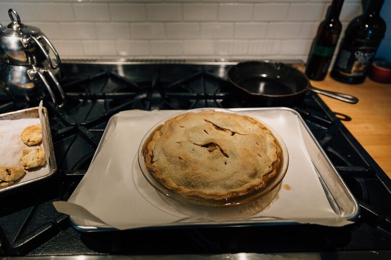 Finished freshly baked favorite apple pie cooling on top of oven