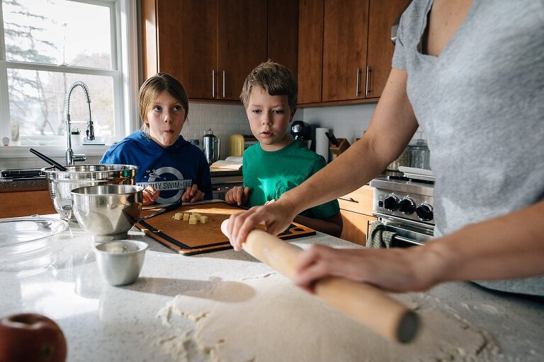 Mom rolls out pie crust