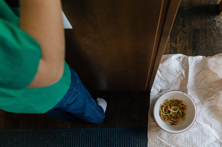 Focus on bowl of apple peels on the floor