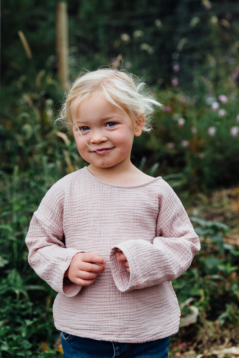 portrait of a girl with windswept hair in the garden