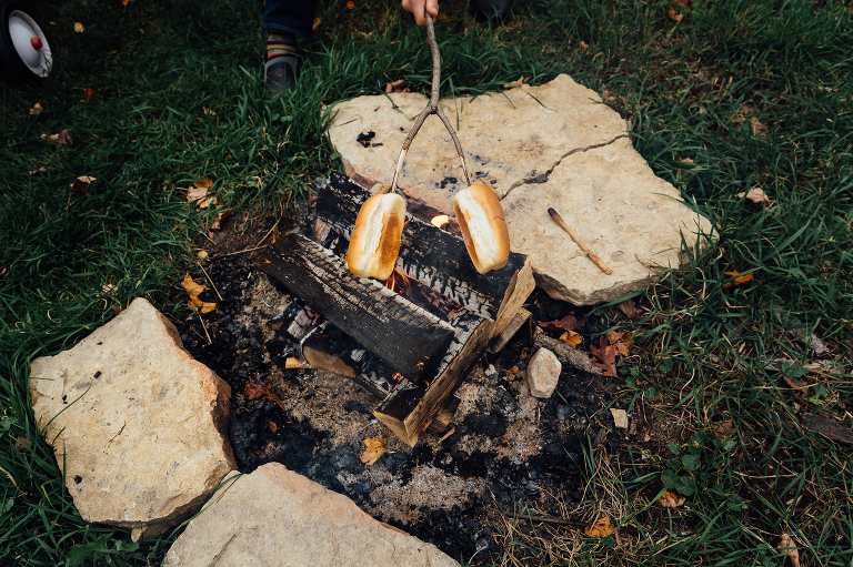 dad toasts buns upside down over open fire in backyard