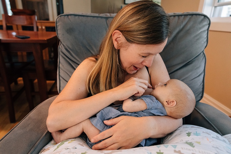 mom smiles at baby in her arms