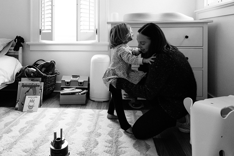 mom helps daughter get into tights