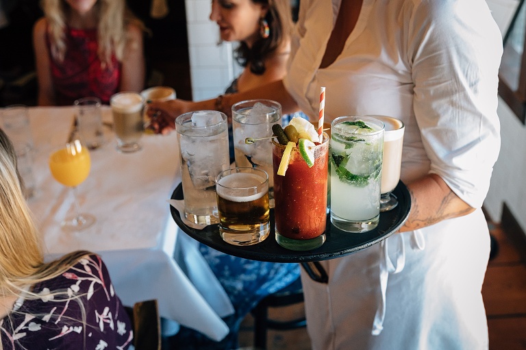 colorful drinks on a waitress's circular tray
