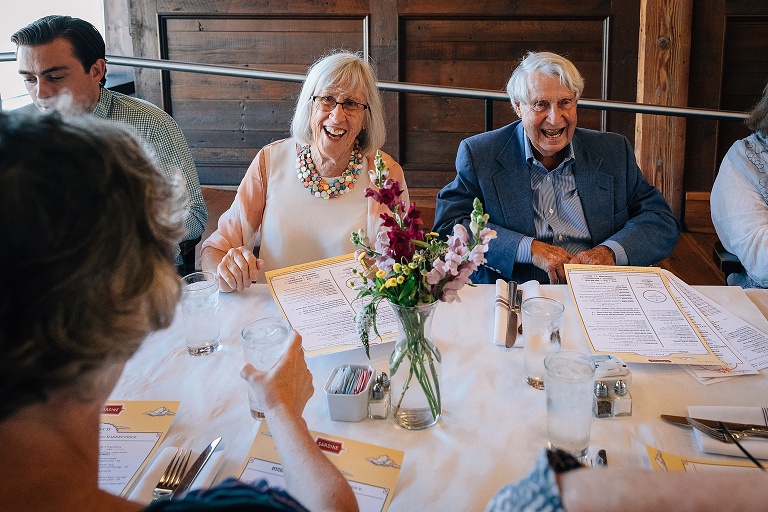 happy senior couple smiling at a restaurant table