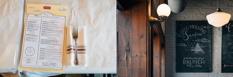 restaurant menu sitting on white tablecloth; chalkboard sign indicating it is brunch time