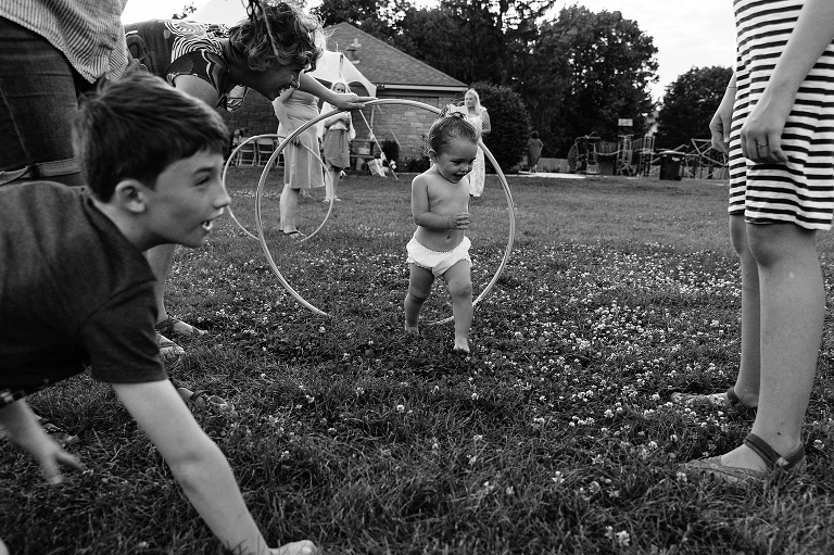 toddler runs through hula hoops 