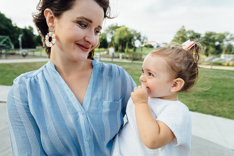 mother and daughter share a smile at the park