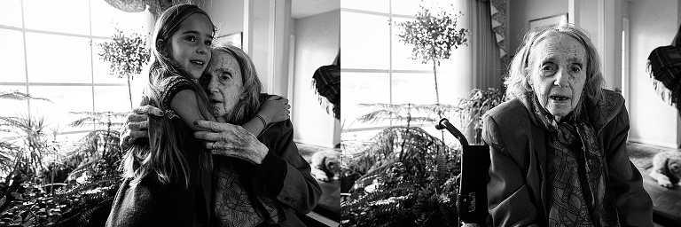 Two pictures. Great-grandmother holds great-granddaughter in embrace; woman makes eye contact with camera. Black and white. Living room.