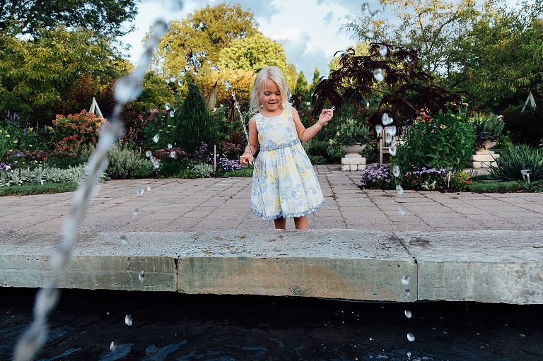 girl plays in fountain at Olbrich Gardens